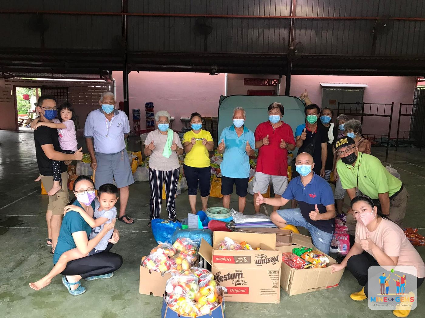 Volunteers and families with donated food supplies