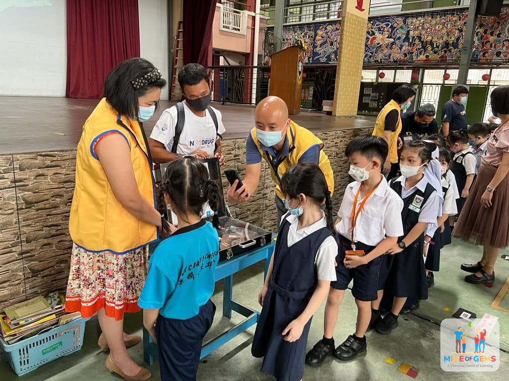 Volunteers giving school supplies to pupils