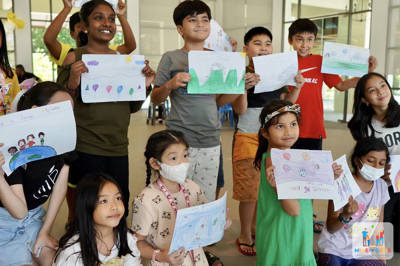 Children proudly holding up their drawings