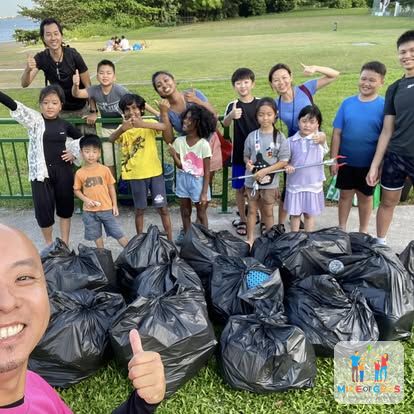 Children with the bags of rubbish they collected