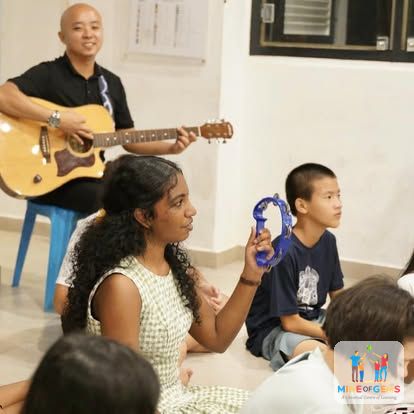 Children making music with guitar and tambourine