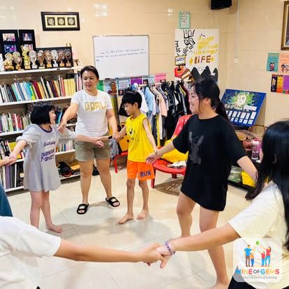 Junior youths holding hands in a circle game