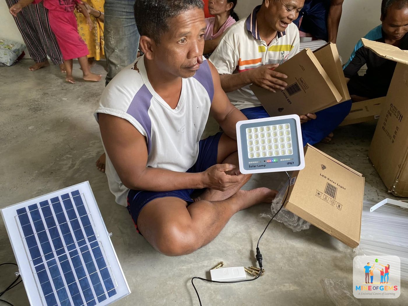 A villager setting up a donated solar lamp
