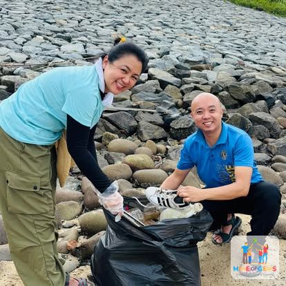 Volunteers collecting rubbish among rocks